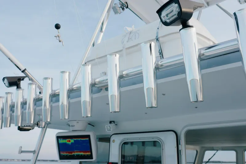 Slide: The Image of Millennium Marine NuWave 37 boat, 2023 model, featuring rod holders and navigation equipment. - 20