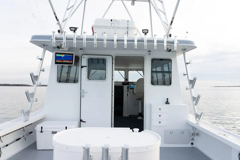 Slide: The Image of 2023 Millennium Marine NuWave 37 boat interior with fishing rod holders and navigation equipment. - 23