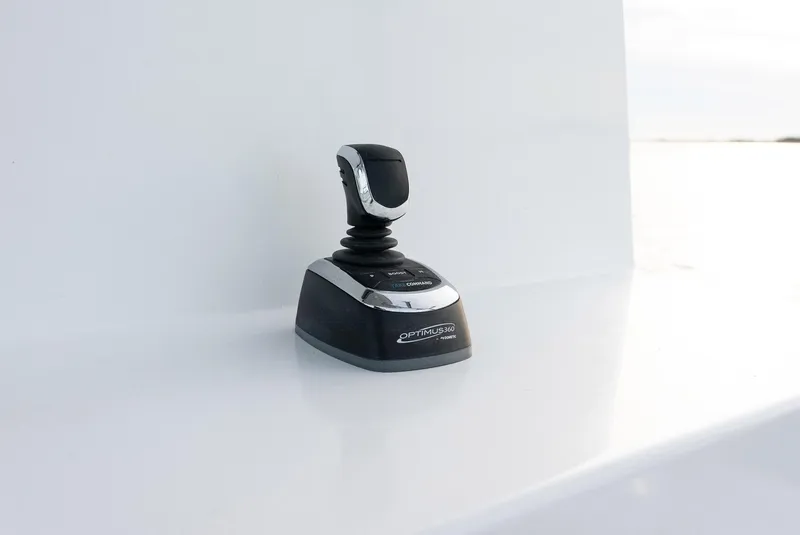 Slide: The Image of Joystick control on Millennium Marine NuWave 37, 2023 model, sleek design. - 24