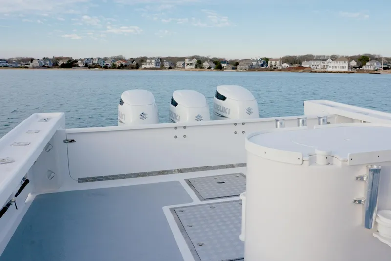 Slide: The Image of Millennium Marine NuWave 37 boat, 2023 model, with triple outboard engines on calm water. - 25