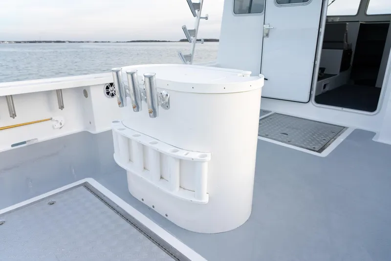 Slide: The Image of 2023 Millennium Marine NuWave 37 boat deck with storage and rod holders. - 27