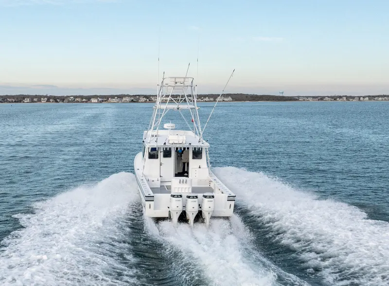 Slide: The Image of Millennium Marine NuWave 37 boat cruising on open water, 2023 model. - 36