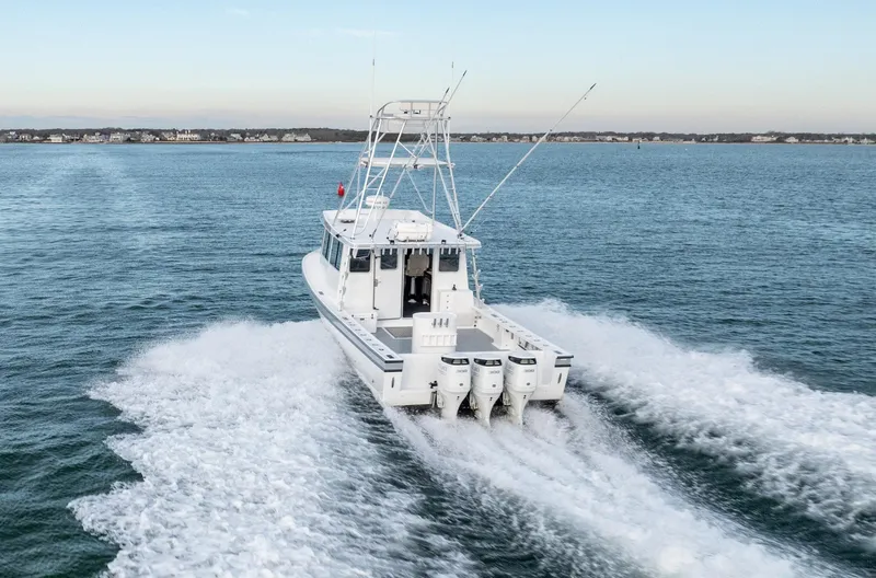 Slide: The Image of Millennium Marine NuWave 37 boat cruising on open water, 2023 model. - 37