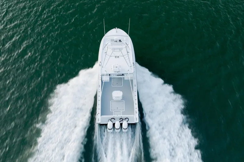 Slide: The Image of Aerial view of 2023 Millennium Marine NuWave 37 boat speeding on water. - 38