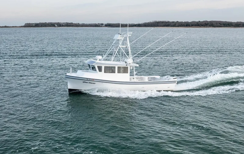 Slide: The Image of 2023 Millennium Marine NuWave 37 boat cruising on open water. - 39