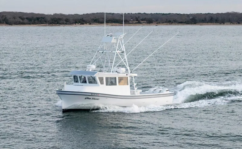 Slide: The Image of 2023 Millennium Marine NuWave 37 boat cruising on open water. - 4