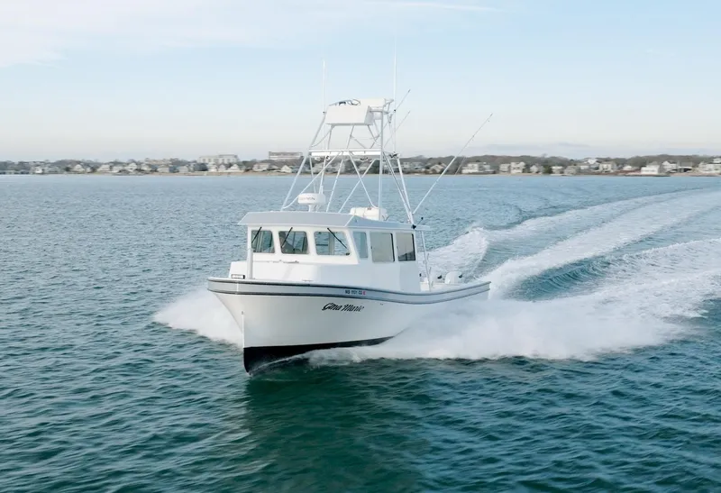 Slide: The Image of 2023 Millennium Marine NuWave 37 boat cruising on open water. - 40