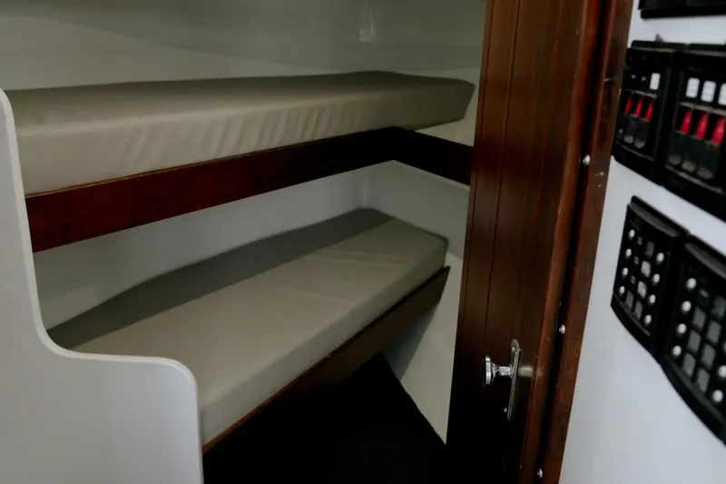 Slide: The Image of Interior of 2023 Millennium Marine NuWave 37 with bunk beds and control panels. - 5