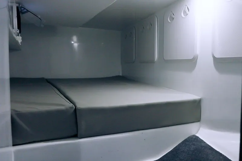 Slide: The Image of Interior cabin of 2023 Millennium Marine NuWave 37 with cushioned sleeping area. - 6