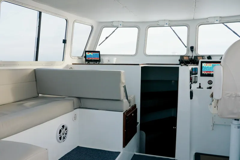 Slide: The Image of Interior of 2023 Millennium Marine NuWave 37 boat with modern seating and navigation equipment. - 8