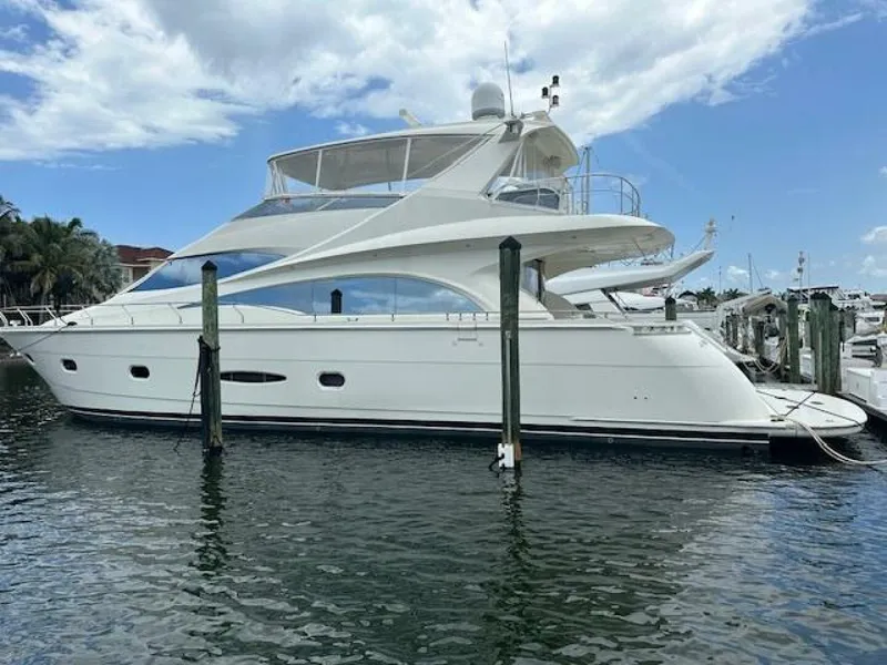 Slide: The Image of 2005 Marquis 65 MY yacht docked in marina under blue sky. - 0
