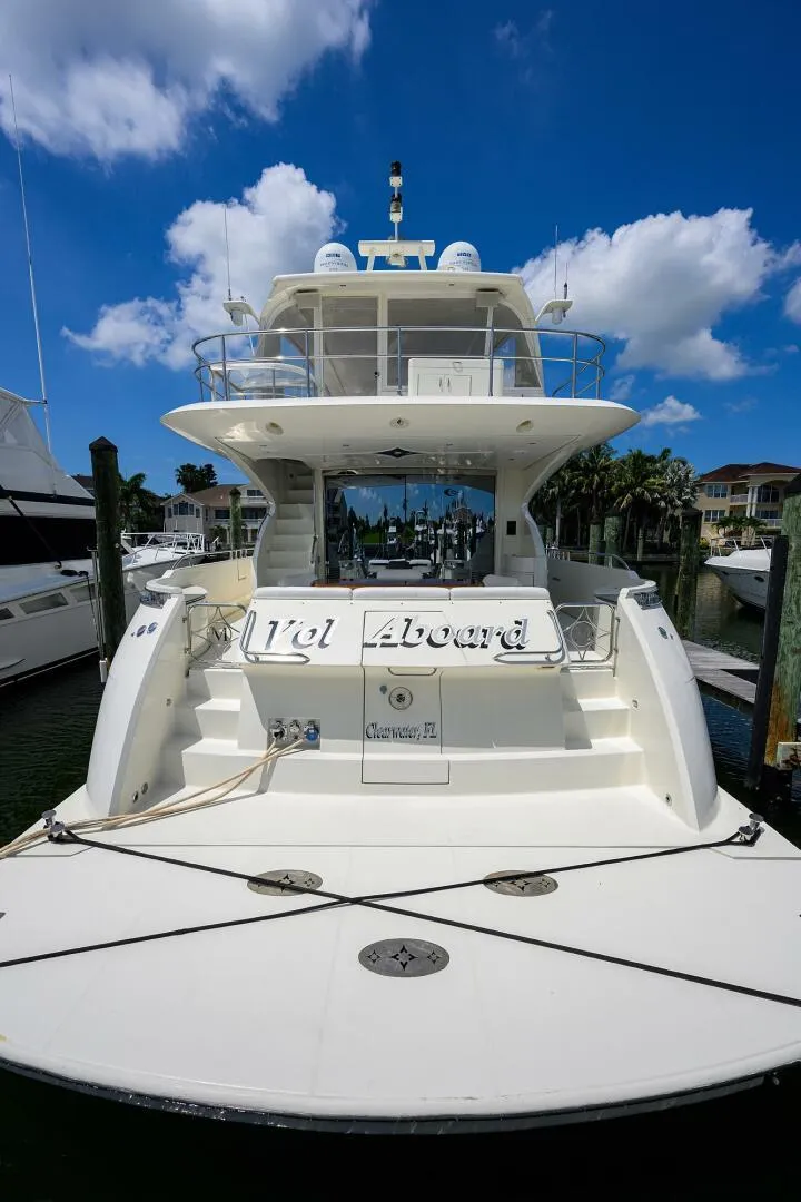 Slide: The Image of 2005 Marquis 65 MY yacht docked under a clear blue sky. - 1
