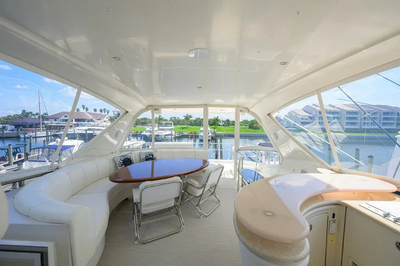 Slide: The Image of Luxurious 2005 Marquis 65 MY yacht interior with elegant seating and scenic marina view. - 35