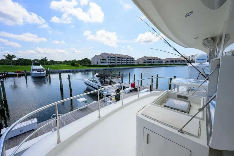 Slide: The Image of Luxury yacht Marquis 65 MY 2005 docked at marina with scenic waterfront view. - 44