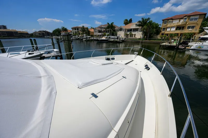 Slide: The Image of 2005 Marquis 65 MY yacht docked in a scenic marina with waterfront homes. - 46