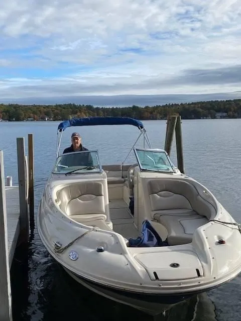Slide: The Image of 2003 Sea Ray 240 Sundeck boat docked on a calm lake. - 10