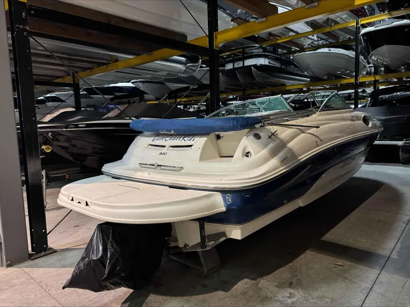 Slide: The Image of 2003 Sea Ray 240 Sundeck boat stored indoors on a rack. - 13