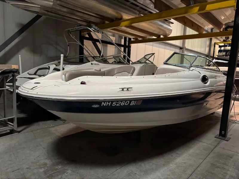 Slide: The Image of 2003 Sea Ray 240 Sundeck boat in indoor storage facility. - 14