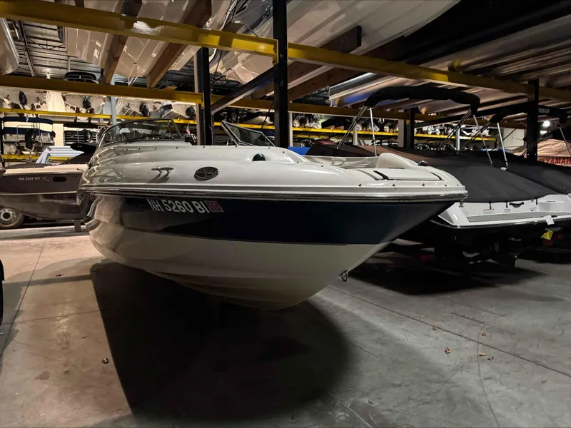 Slide: The Image of 2003 Sea Ray 240 Sundeck boat stored indoors, surrounded by other boats. - 15