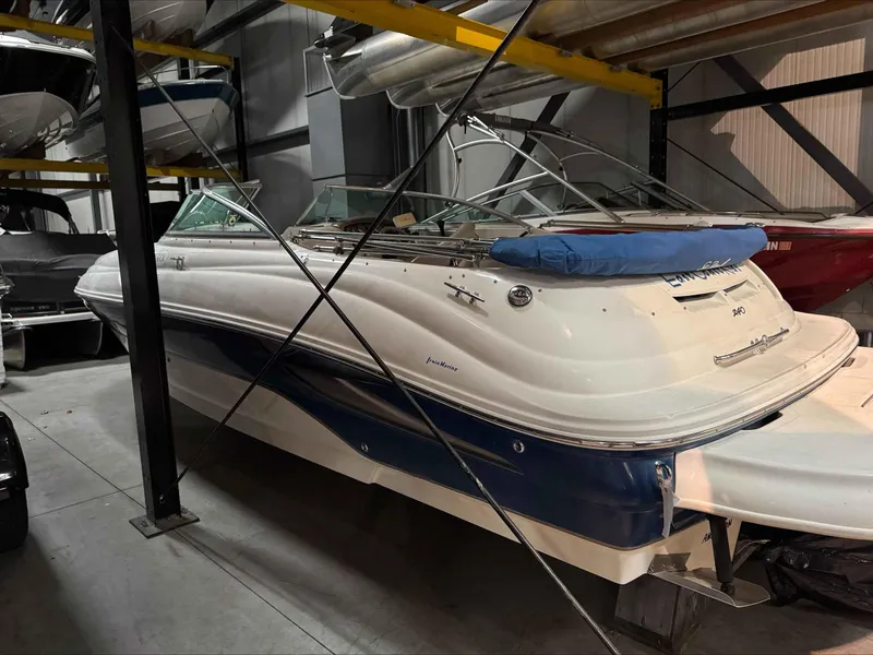 Slide: The Image of 2003 Sea Ray 240 Sundeck boat stored indoors on a rack. - 16