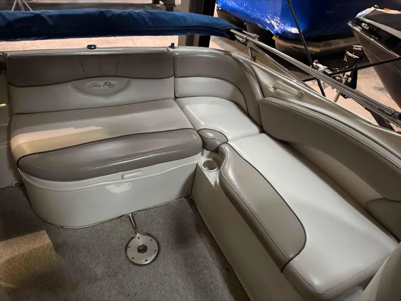Slide: The Image of 2003 Sea Ray 240 Sundeck interior seating with gray and white upholstery. - 19