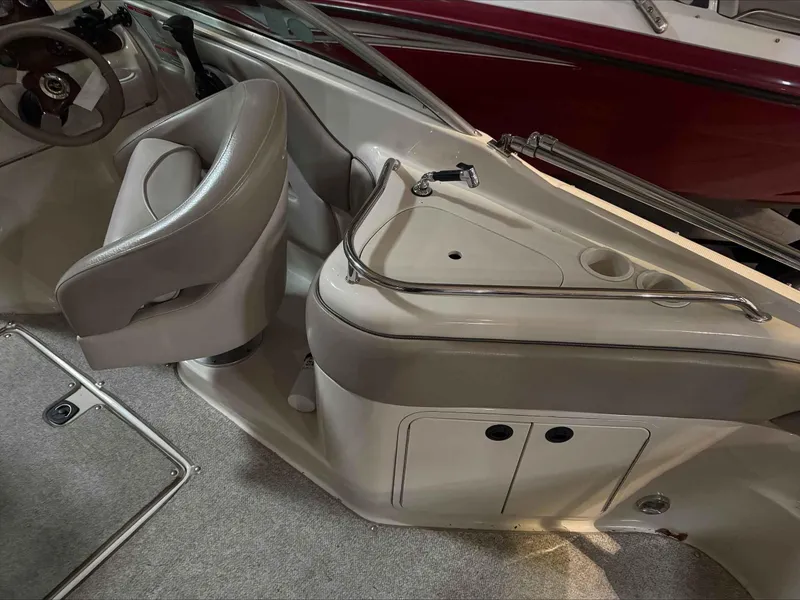 Slide: The Image of Interior of a 2003 Sea Ray 240 Sundeck boat with steering wheel and seating area. - 20