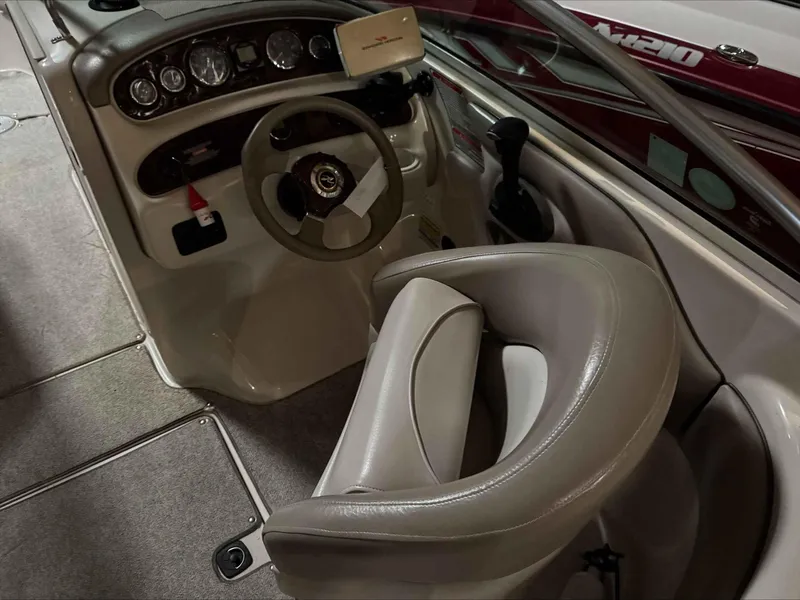 Slide: The Image of 2003 Sea Ray 240 Sundeck boat interior with steering wheel and dashboard. - 21