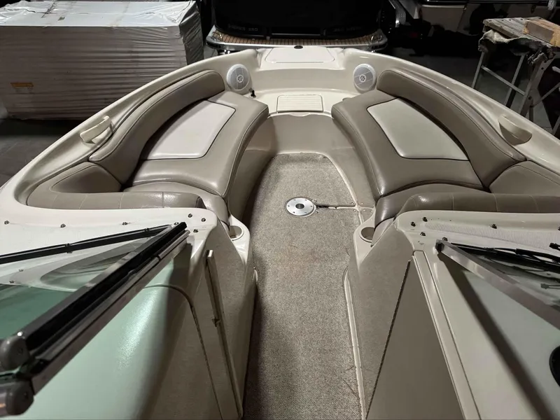 Slide: The Image of 2003 Sea Ray 240 Sundeck interior with beige seating and carpeted floor. - 23
