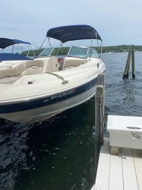 Slide: The Image of 2003 Sea Ray 240 Sundeck boat docked on a lake. - 8