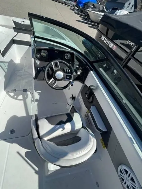 Slide: The Image of 2022 Monterey M22 boat interior with steering wheel and seating area. - 9