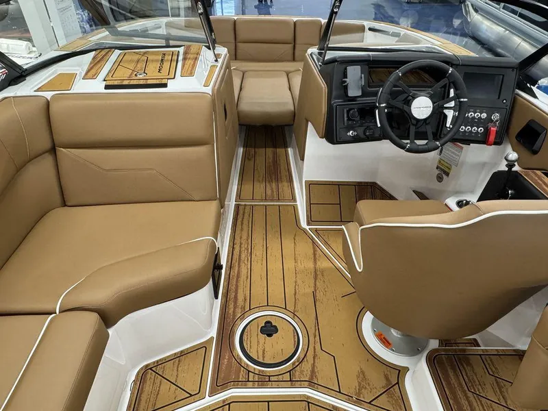 Slide: The Image of 2025 Moomba Max interior with tan seating and wood-style flooring. - 11