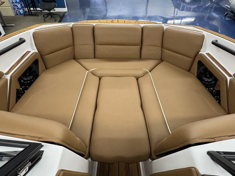 Slide: The Image of 2025 Moomba Max boat interior with tan cushioned seating and modern design. - 15