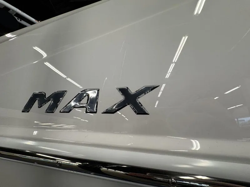 Slide: The Image of 2025 Moomba Max boat with chrome lettering on white surface. - 2