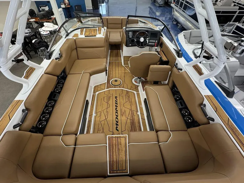 Slide: The Image of 2025 Moomba Max boat interior with tan seating and modern dashboard design. - 4