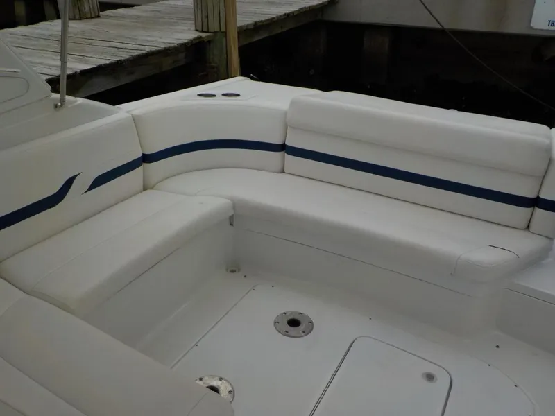 Slide: The Image of 2006 Formula 330 SS boat interior with white seating and blue accents. - 10