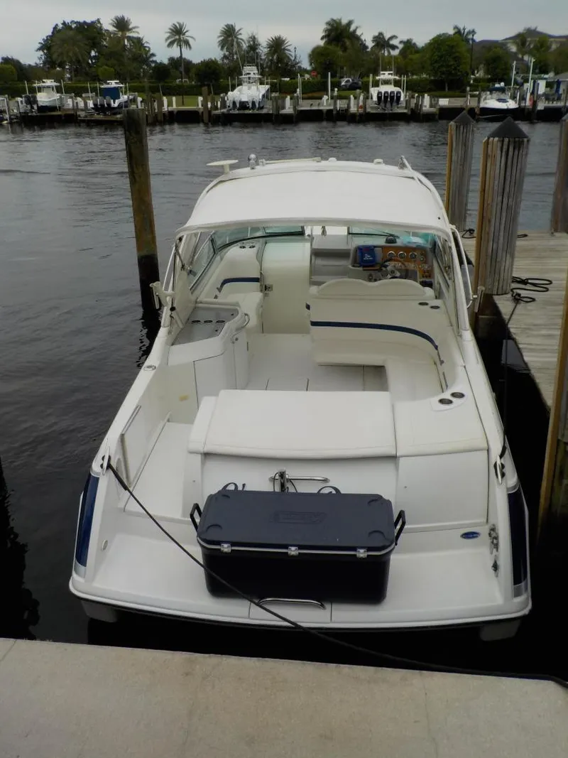 Slide: The Image of 2006 Formula 330 SS boat docked at marina with lush surroundings. - 13