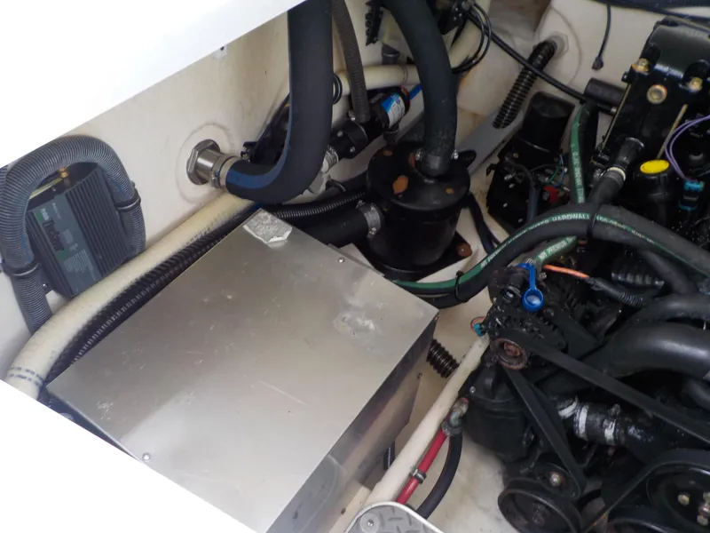 Slide: The Image of Engine compartment of 2006 Formula 330 SS boat with visible hoses and components. - 15
