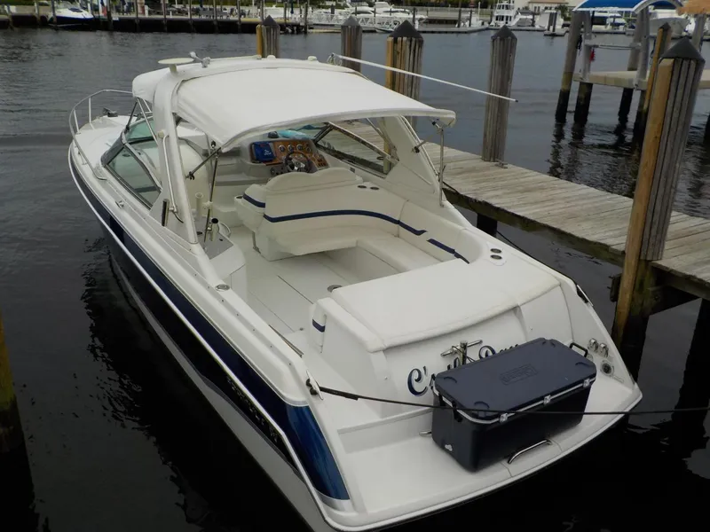 Slide: The Image of 2006 Formula 330 SS boat docked at marina, featuring sleek design and spacious seating. - 18