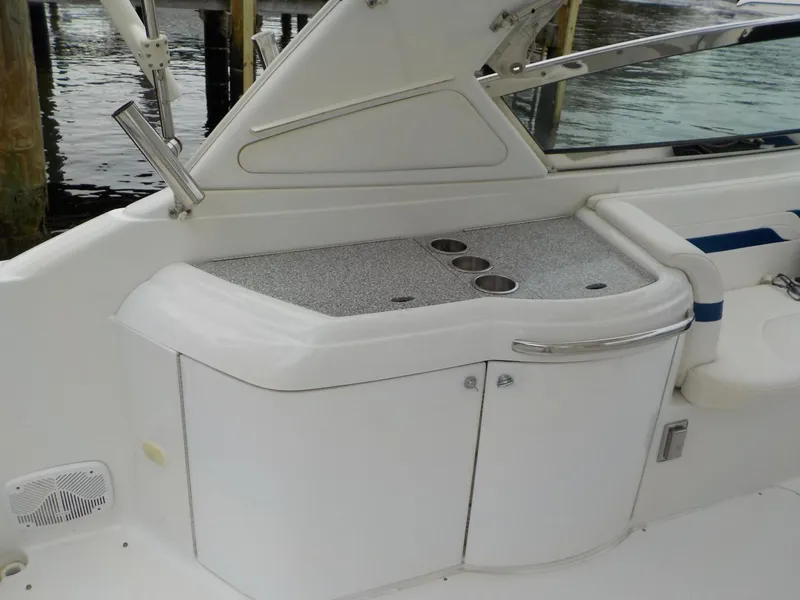 Slide: The Image of 2006 Formula 330 SS boat interior with sleek white cabinetry and cup holders. - 8