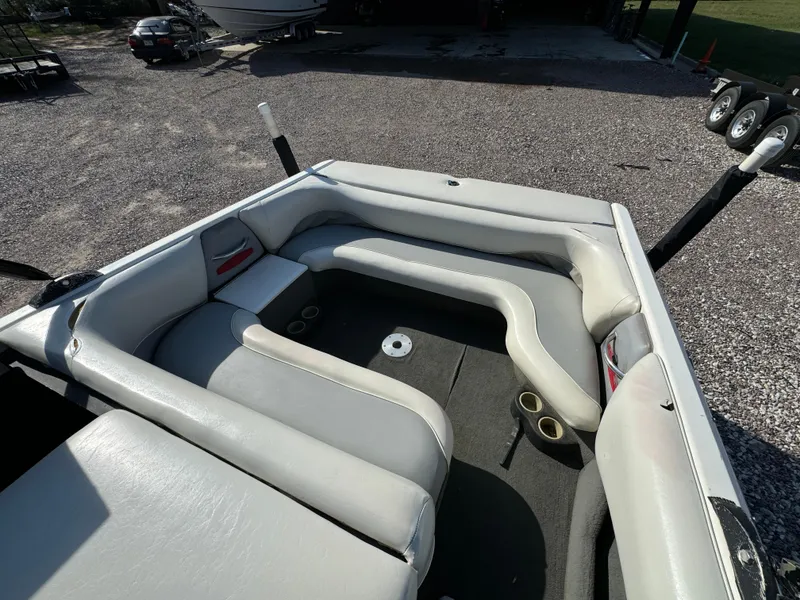 Slide: The Image of 2003 Malibu Wakesetter 23 XTi boat interior with gray seating and cup holders. - 13