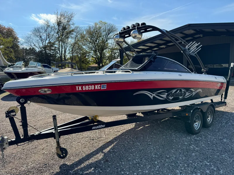 Slide: The Image of 2003 Malibu Wakesetter 23 XTi boat on trailer, parked outdoors. - 5