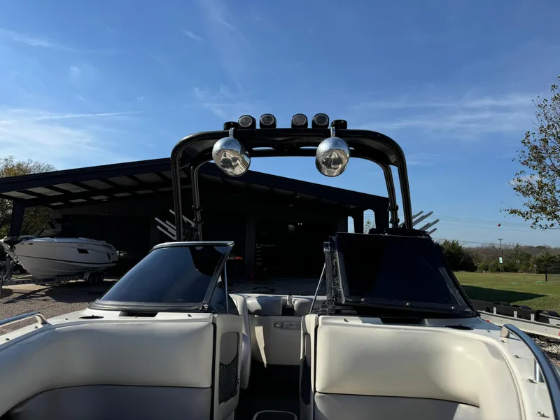 Slide: The Image of 2003 Malibu Wakesetter 23 XTi boat with tower and speakers, parked outdoors. - 7