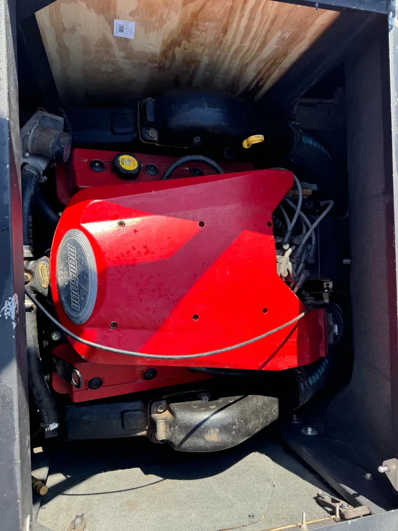 Slide: The Image of 2003 Malibu Wakesetter 23 XTi engine with red cover in boat compartment. - 8