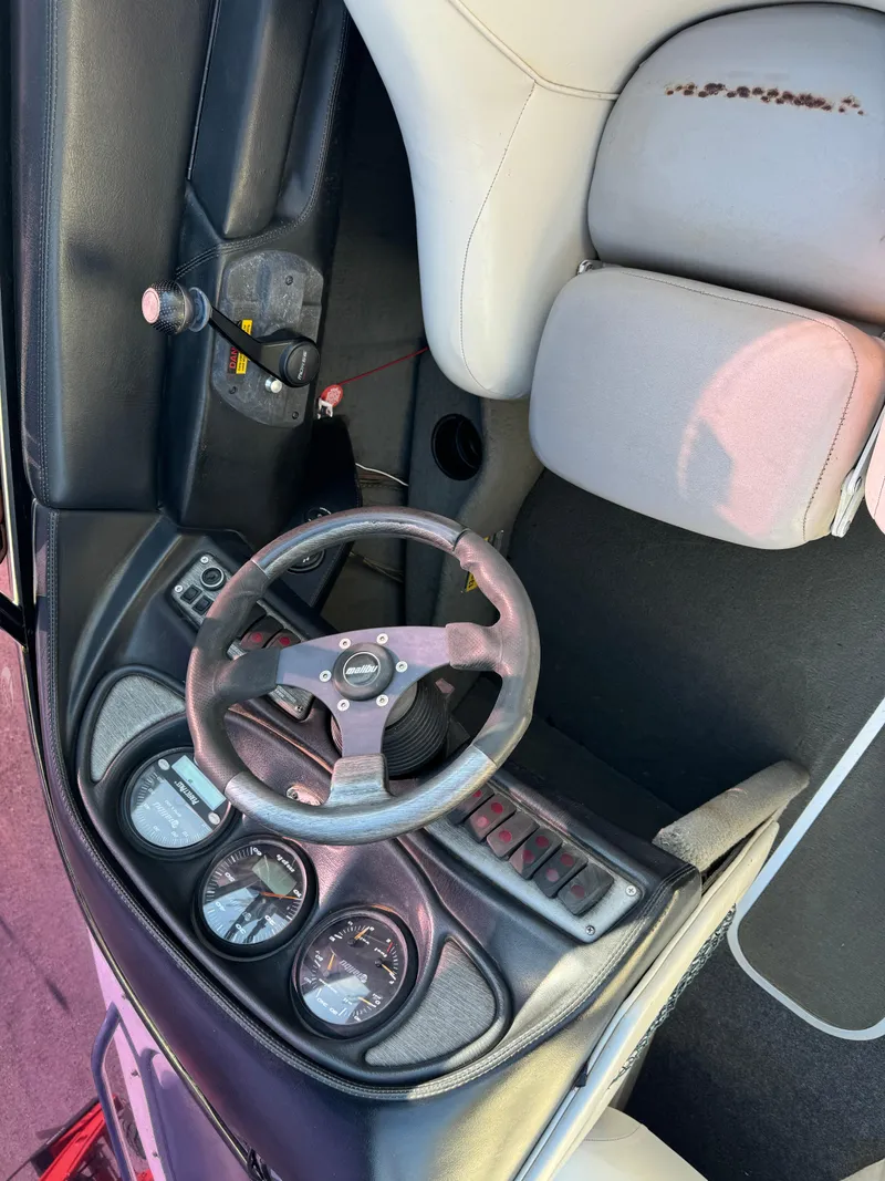 Slide: The Image of 2003 Malibu Wakesetter 23 XTi boat dashboard with steering wheel and gauges. - 9