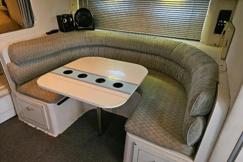 Slide: The Image of 1988 Wellcraft Gran Sport interior with curved seating and table. - 13