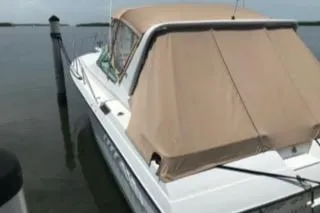 Slide: The Image of 1988 Wellcraft Gran Sport boat docked with tan cover. - 14