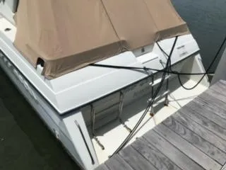 Slide: The Image of 1988 Wellcraft Gran Sport boat docked with beige cover. - 2