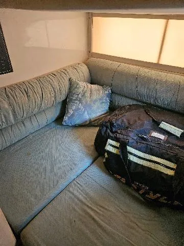 Slide: The Image of Interior of 1988 Wellcraft Gran Sport with blue seating and a duffel bag. - 3