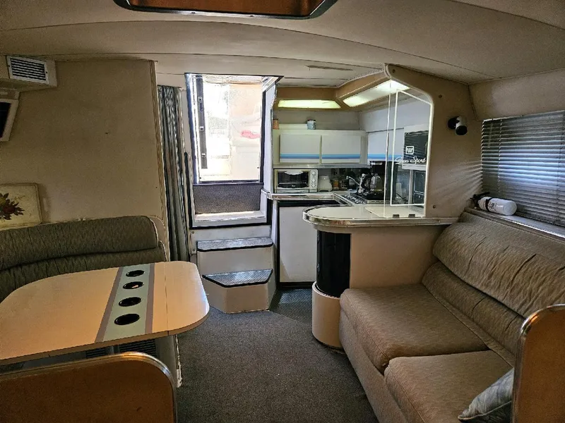 Slide: The Image of Interior of a 1988 Wellcraft Gran Sport boat with cozy seating and kitchenette. - 5
