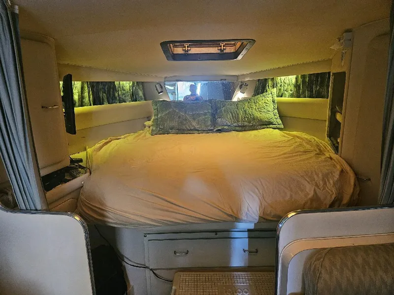 Slide: The Image of Interior cabin of 1988 Wellcraft Gran Sport boat with cozy bed and ambient lighting. - 6